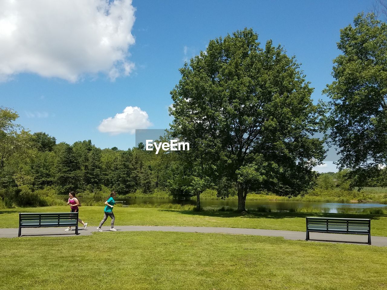 MEN PLAYING ON FIELD AGAINST SKY