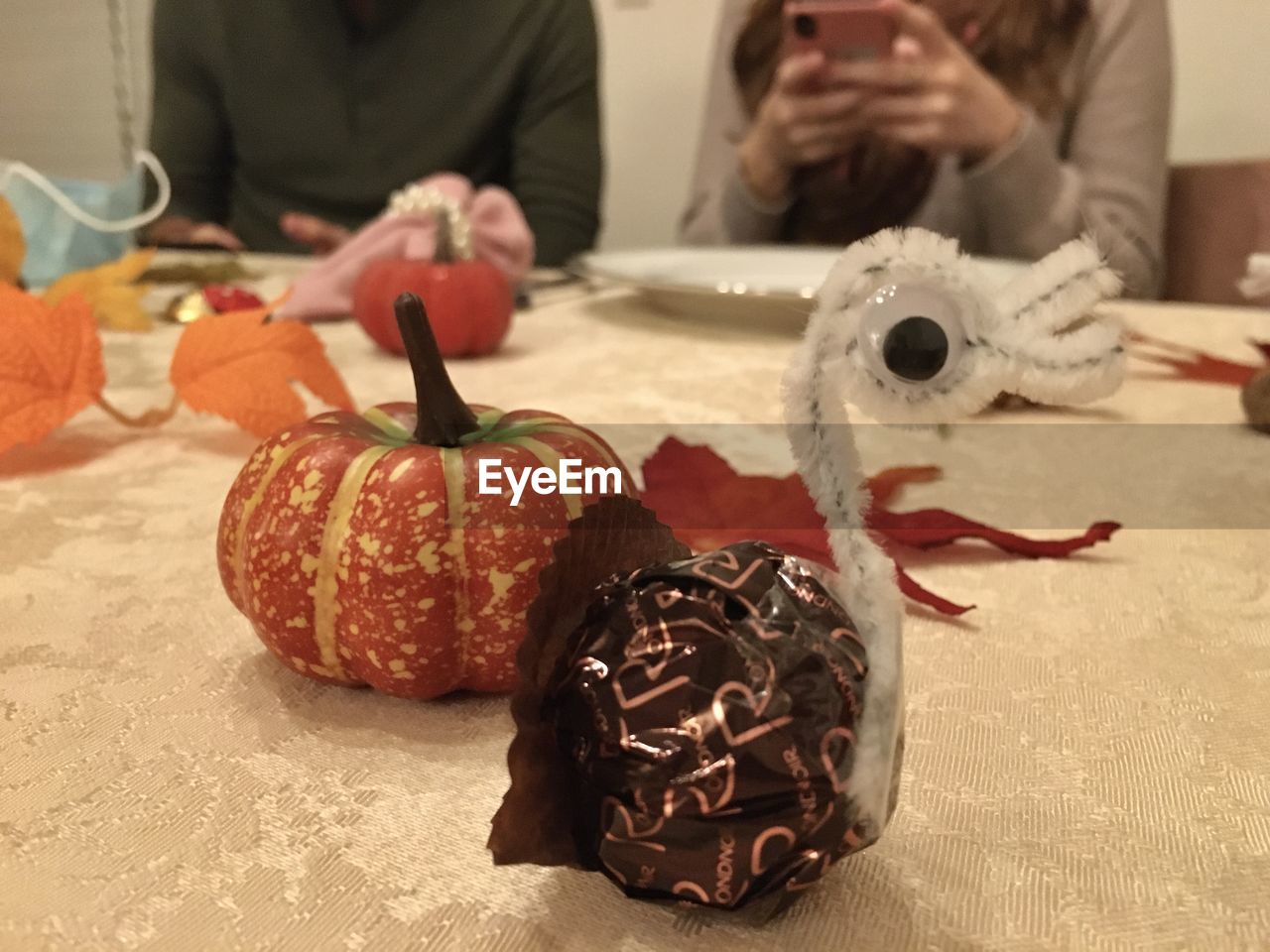 CLOSE-UP OF PUMPKIN ON TABLE DURING HALLOWEEN