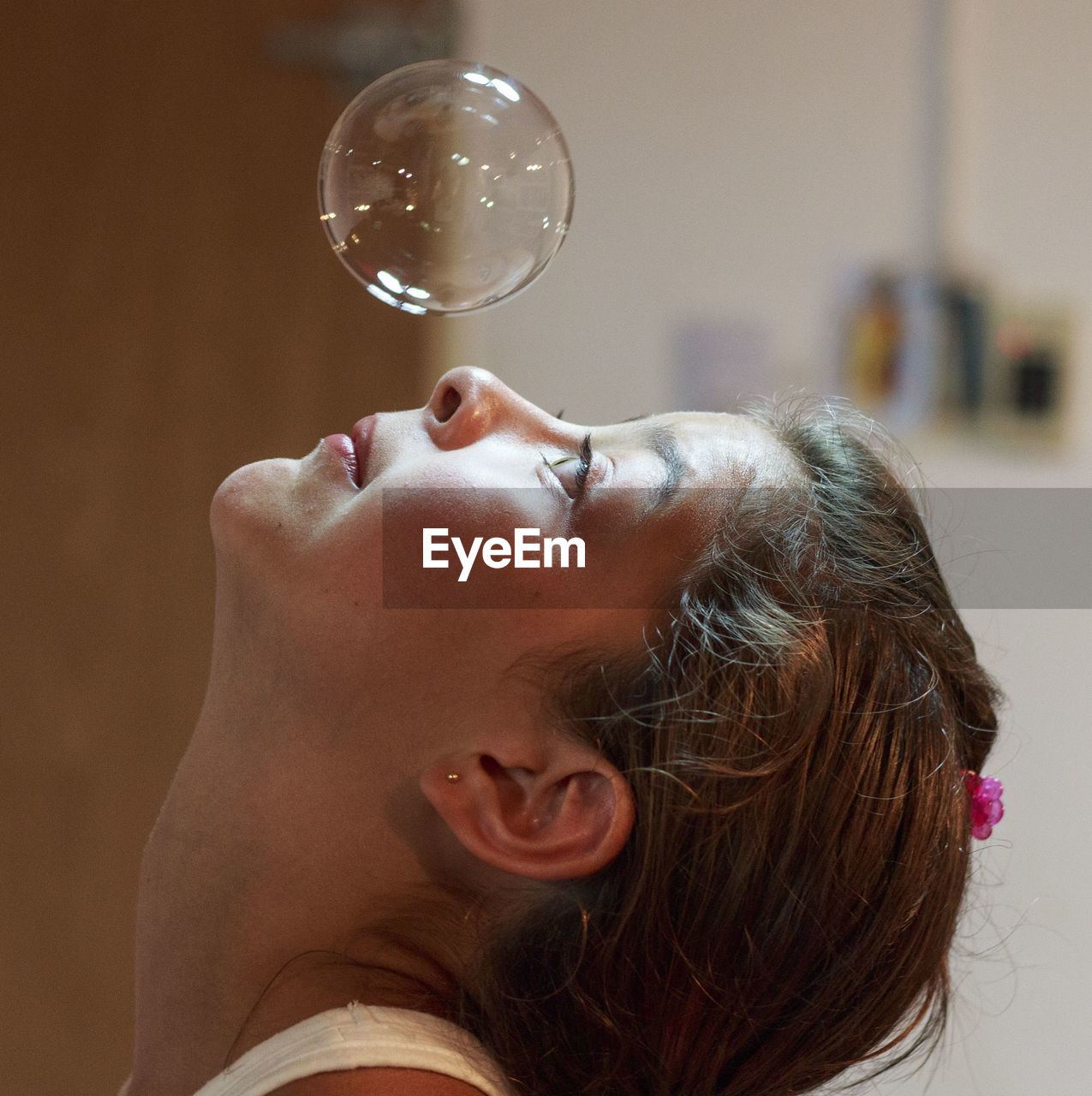 Close-up of girl looking at bubbles