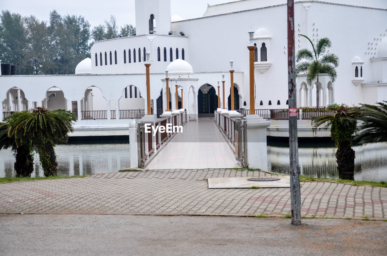 Street by mosque in city