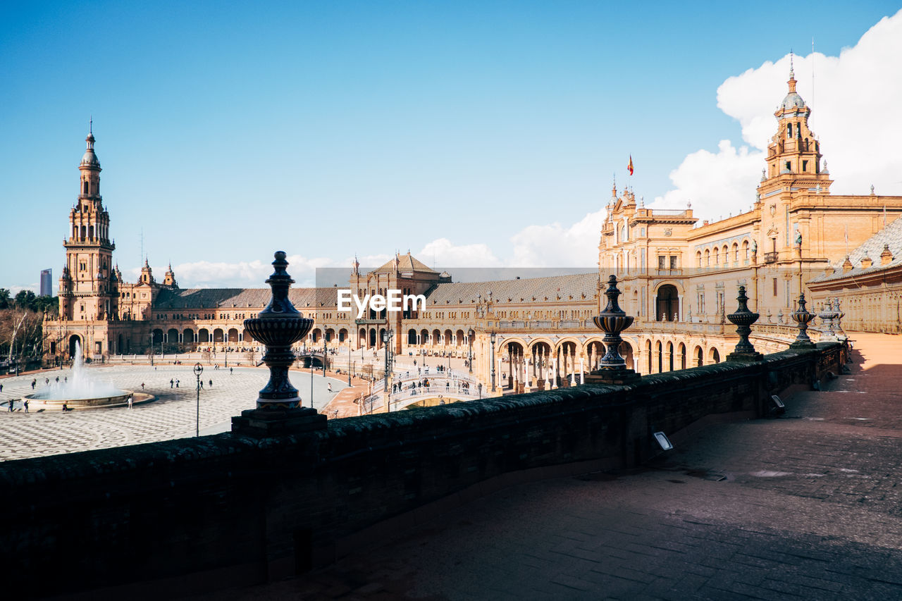 Historic buildings at plaza de espana against blue sky