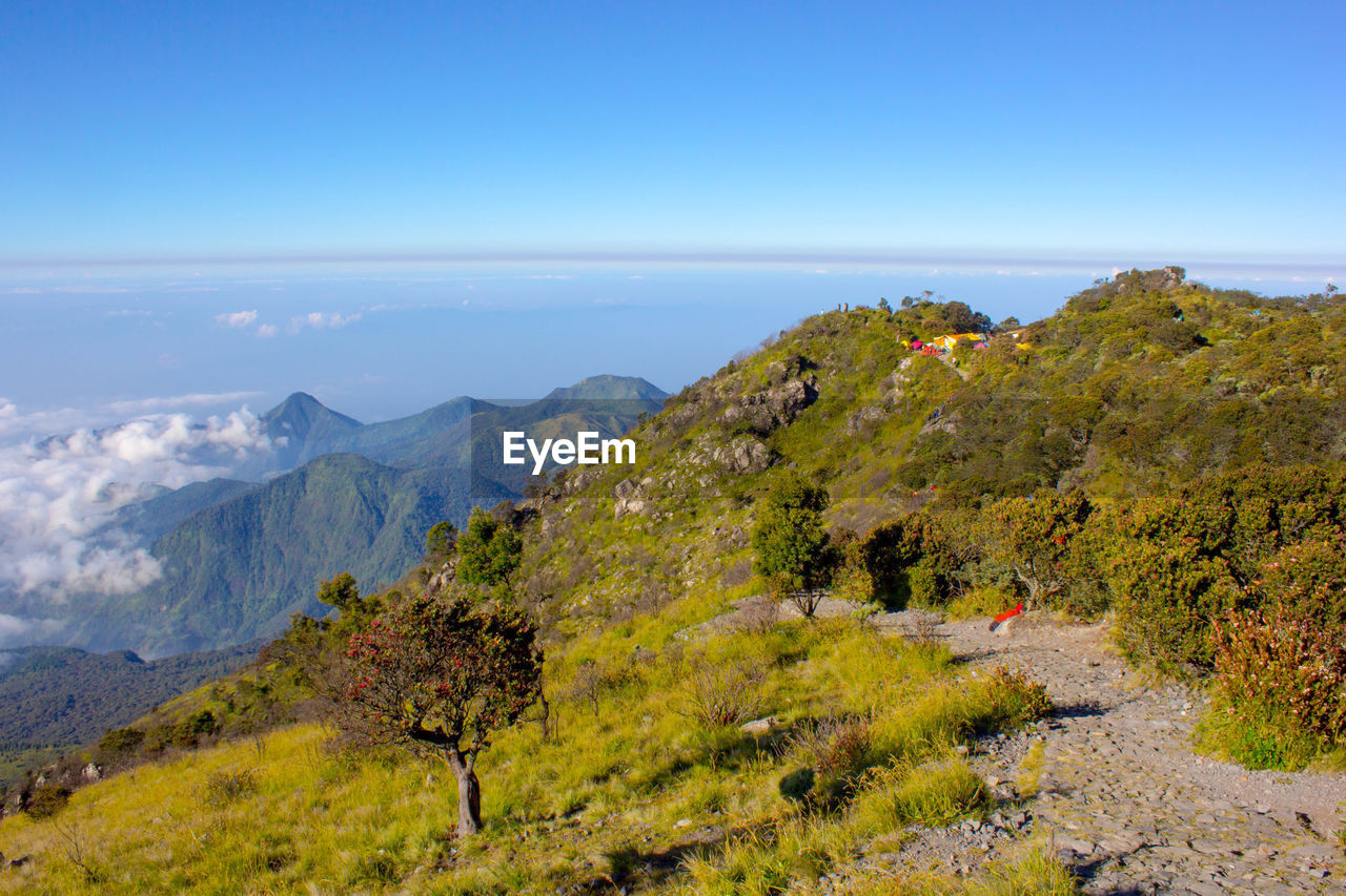 Scenic view of mountains against blue sky