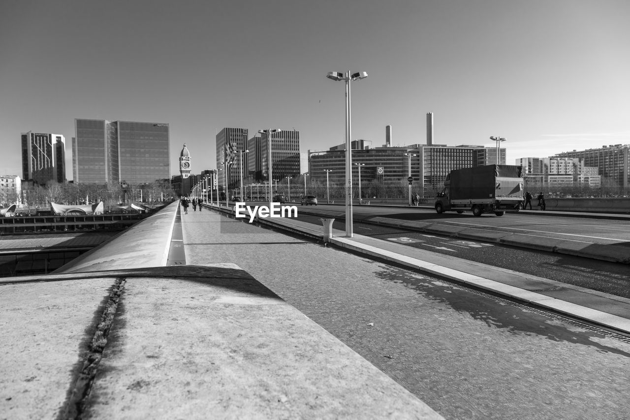 VIEW OF RAILROAD TRACKS AND BUILDINGS AGAINST SKY