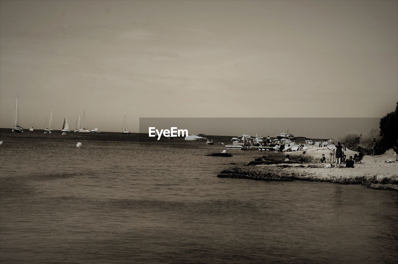 SCENIC VIEW OF HARBOR AGAINST SKY