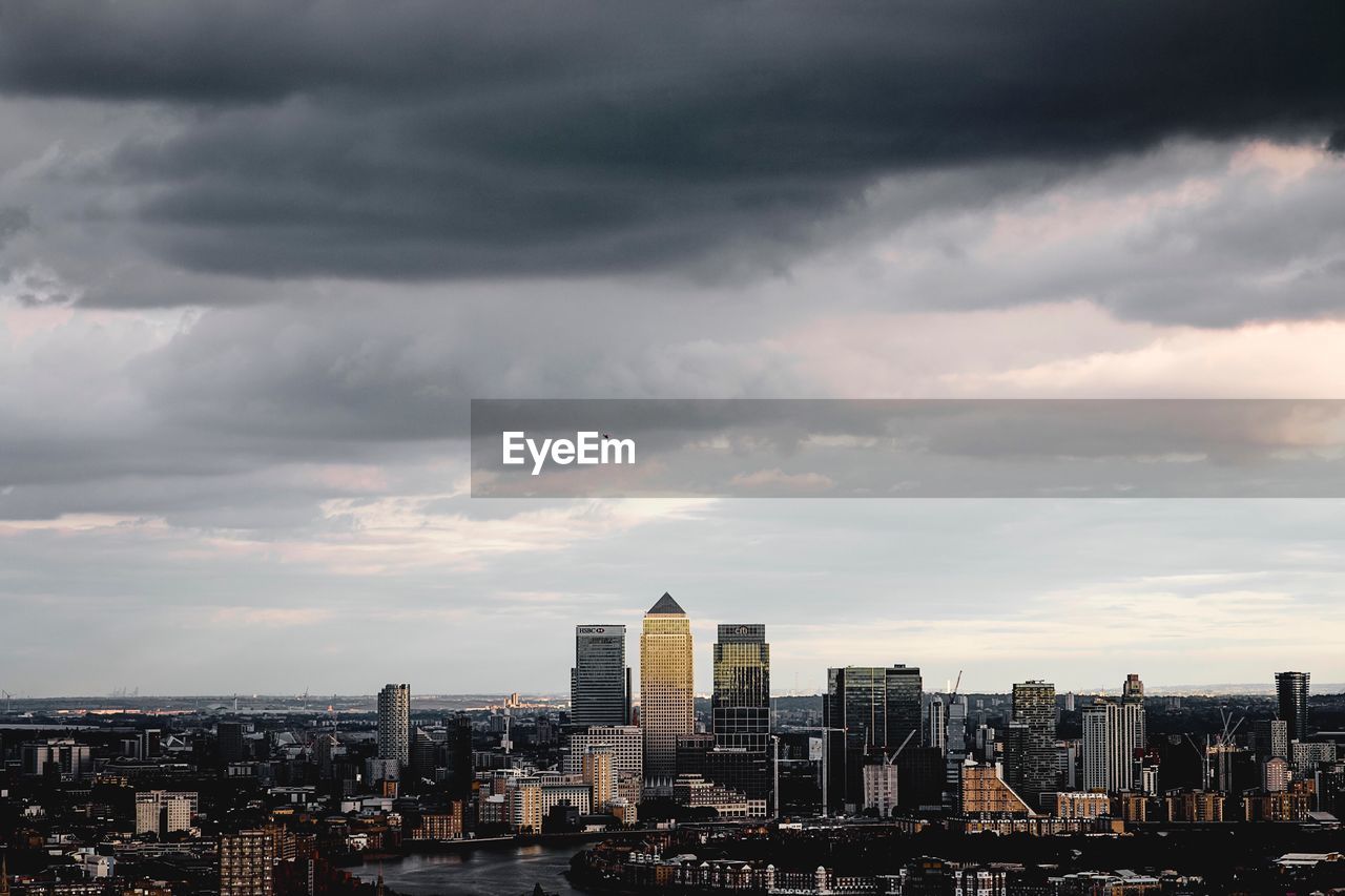 Cityscape against cloudy sky