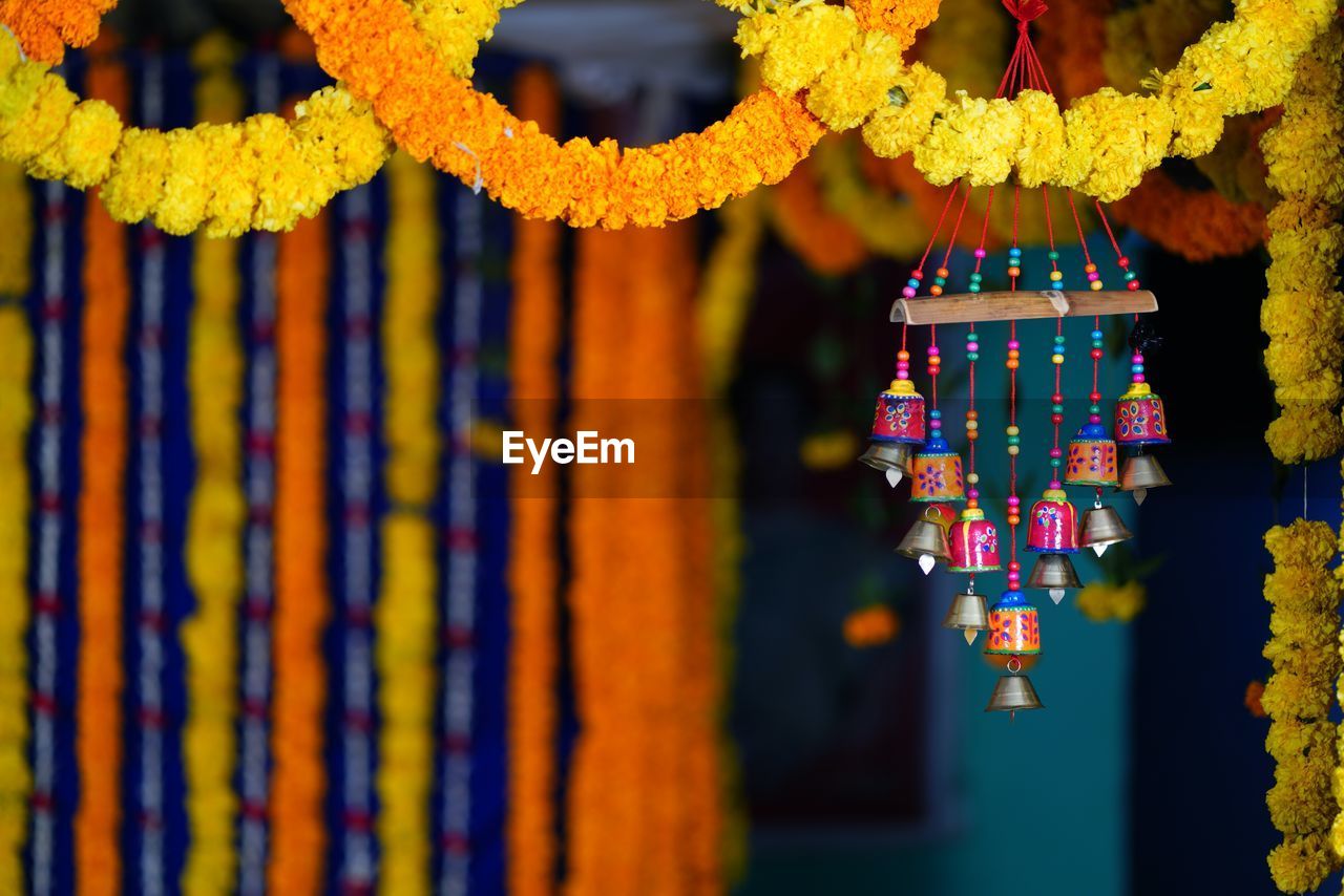 yellow, hanging, flower, multi colored, no people, decoration, close-up, tradition, pattern, craft, focus on foreground