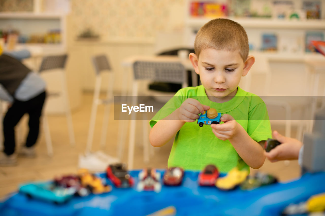 Cute boy playing with toy