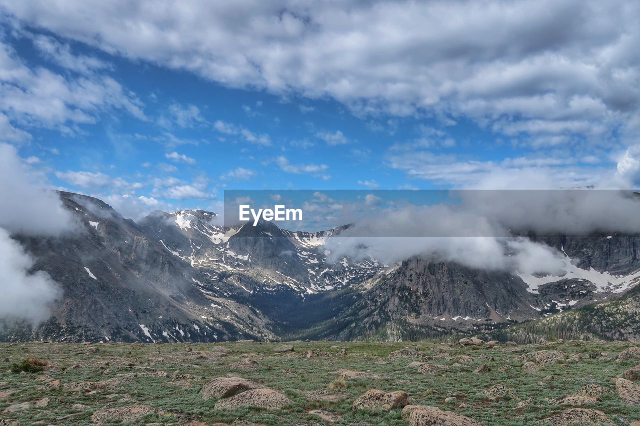 Landscape of billowing clouds atop the mountains in rocky mountain national park in colorado