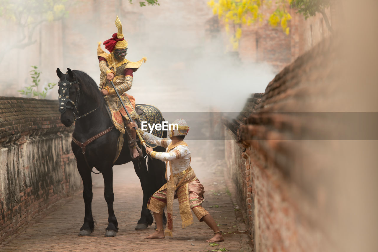 animal, mammal, animal themes, domestic animals, horse, livestock, adult, animal wildlife, nature, tradition, riding, activity, screenshot, pet, men, traditional clothing, working animal, travel, outdoors, one animal, clothing, rural scene, landscape, full length, architecture, person, transportation, fog, occupation, motion, history, one person
