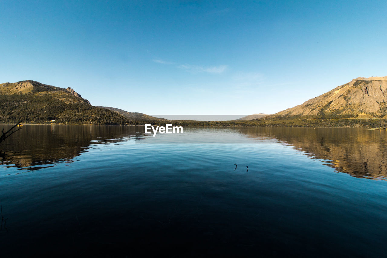 Scenic view of lake against blue sky