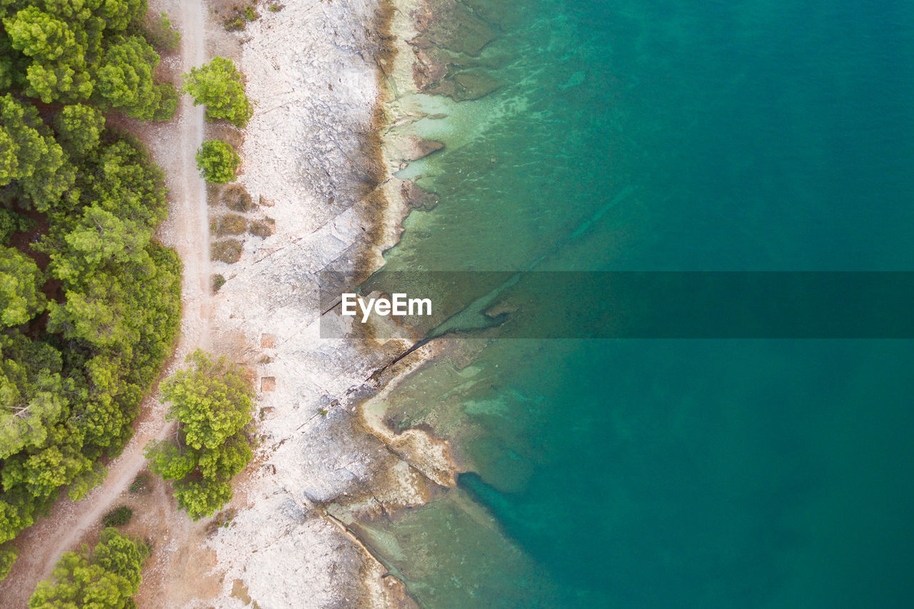 HIGH ANGLE VIEW OF SURF ON THE SHORE