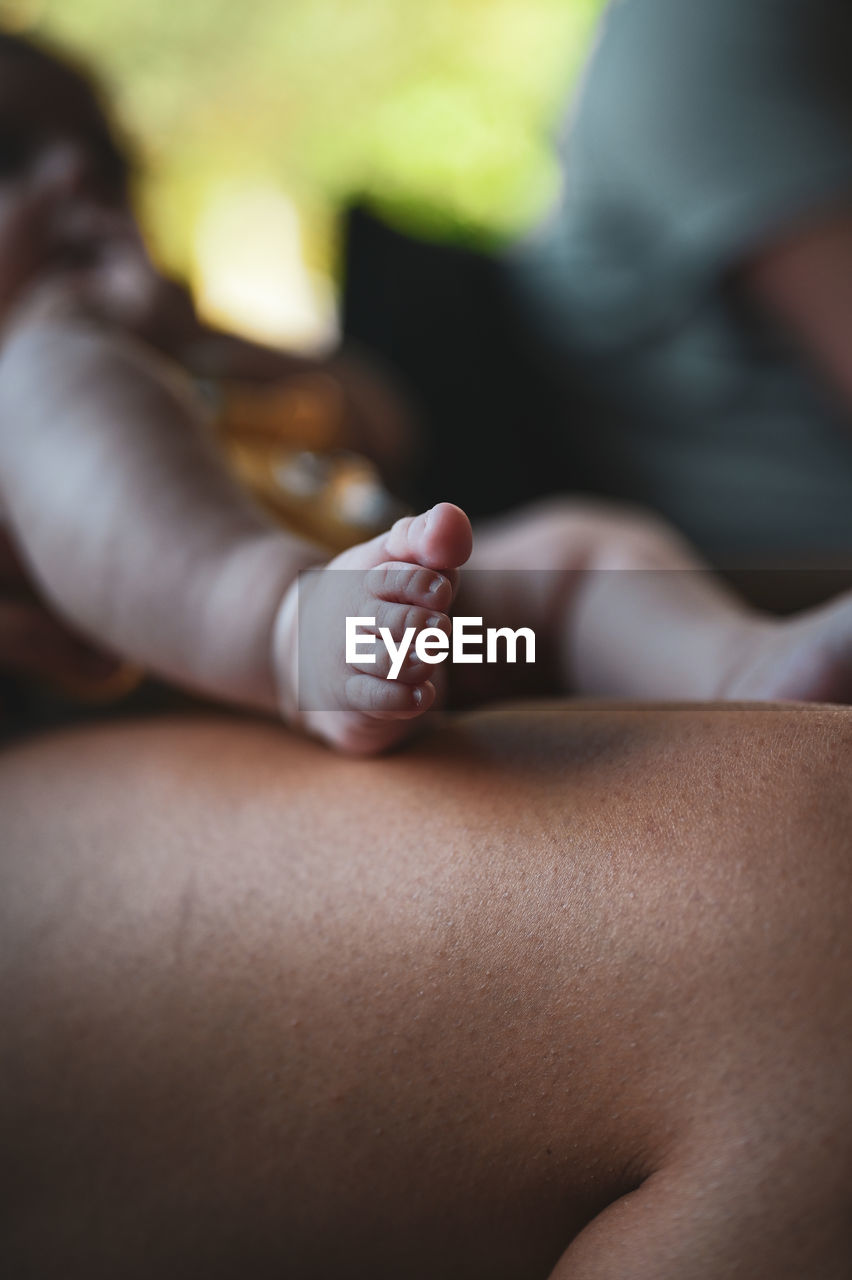 adult, close-up, relaxation, women, one person, hand, human leg, young adult, lifestyles, lying down, indoors, skin, focus on foreground, female, sitting, person, human skin, midsection, healthcare and medicine, emotion