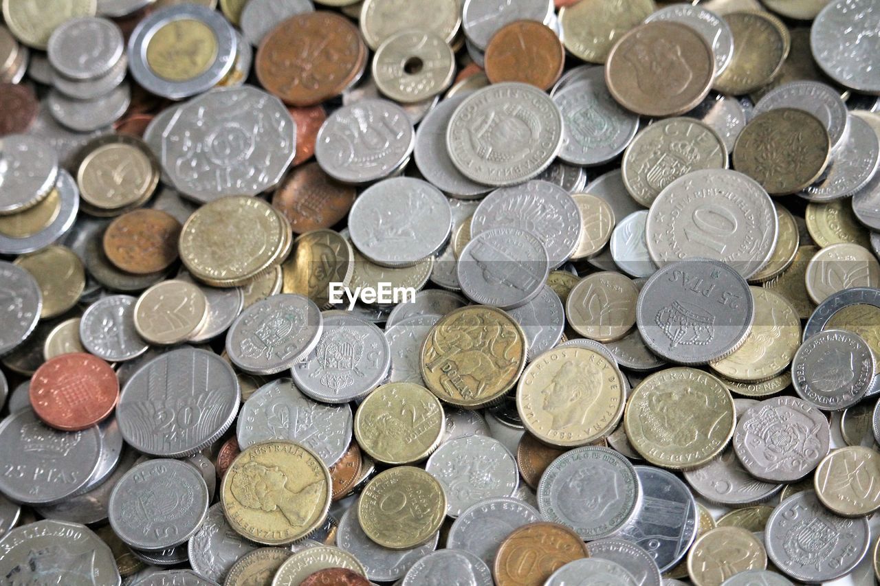 FULL FRAME SHOT OF COINS ON METAL