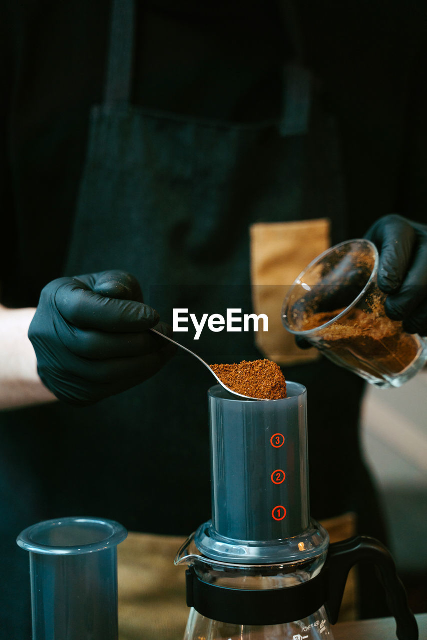 Waiter preparing coffee in coffee machine