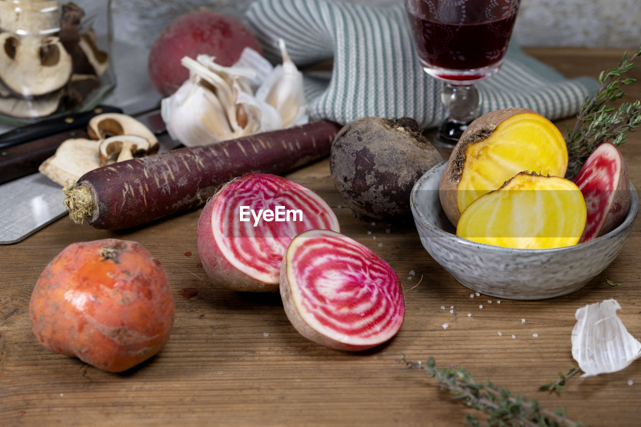 Yellow red orange beet with purple carrot and dry mushrooms