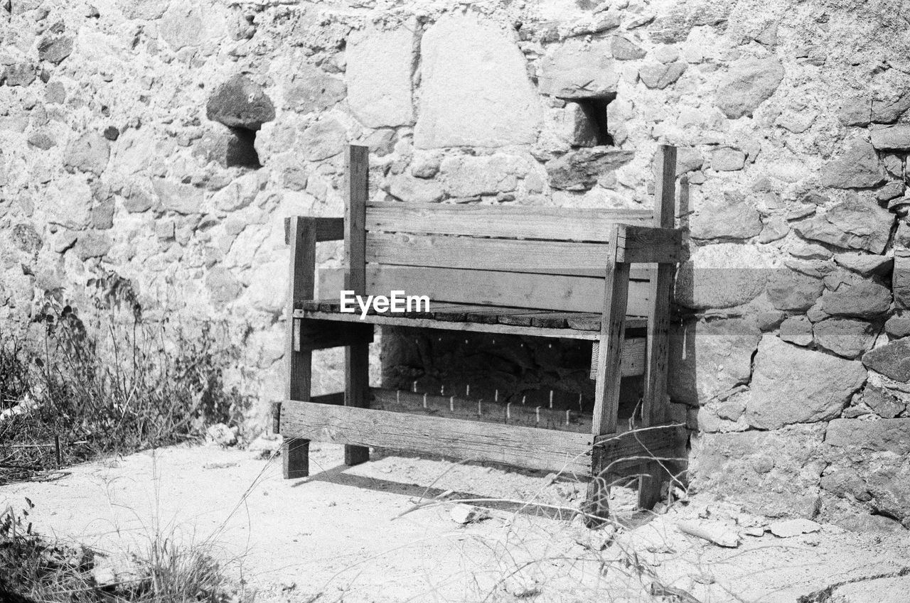 OLD BENCH AGAINST BUILDING