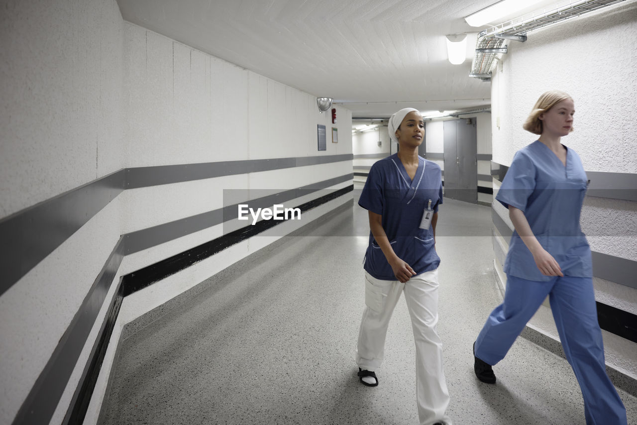 Female doctors walking through hospital corridor