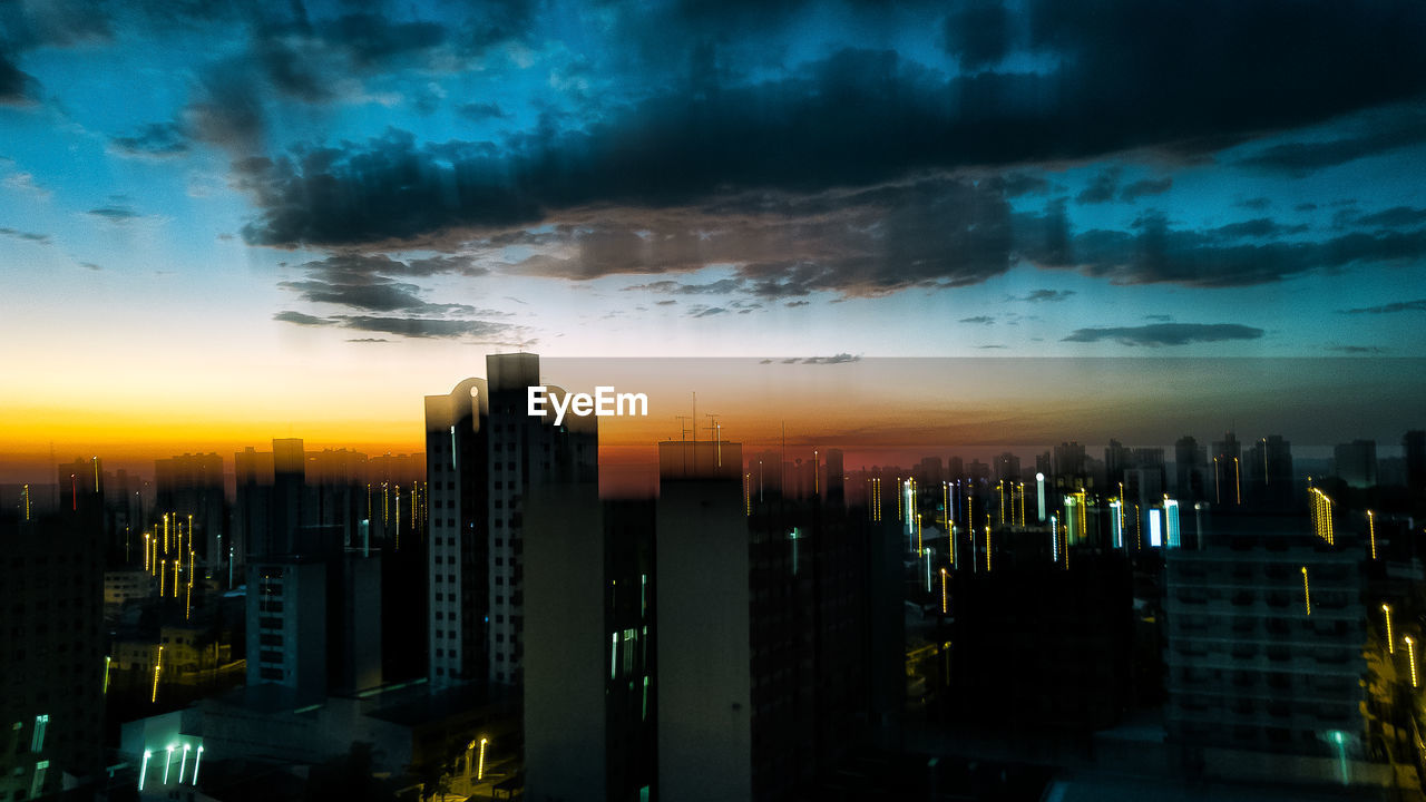 CITY BUILDINGS AGAINST SKY DURING SUNSET