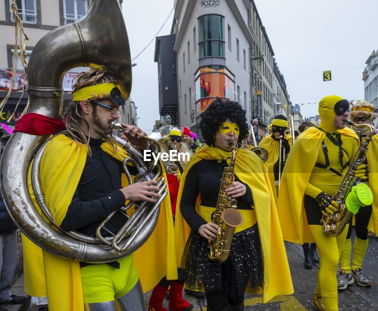 PEOPLE STANDING ON YELLOW STREET