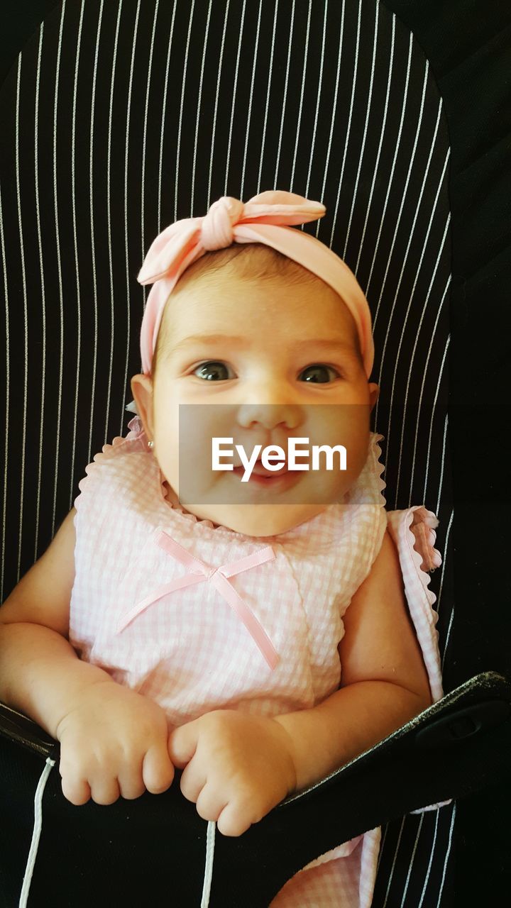 Close-up of baby girl in stroller