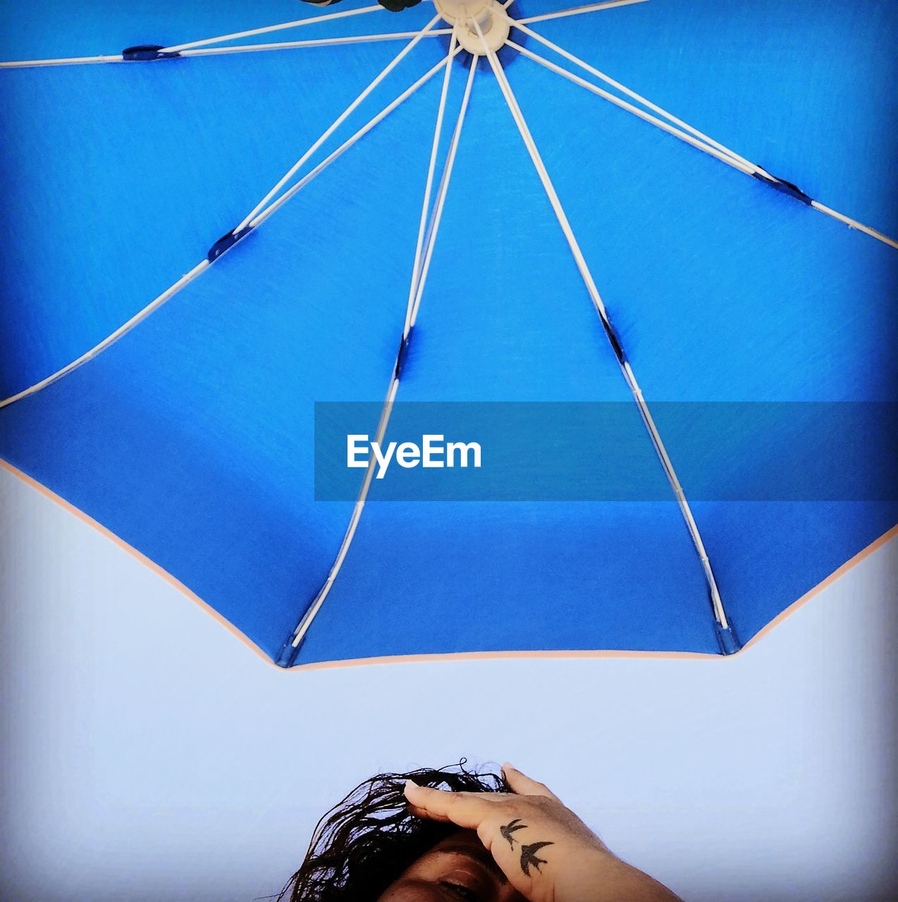 Low angle view of woman against umbrella
