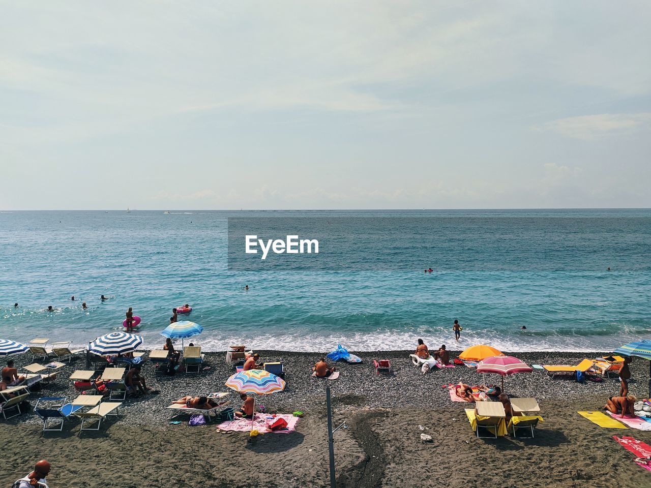 People on beach against sky