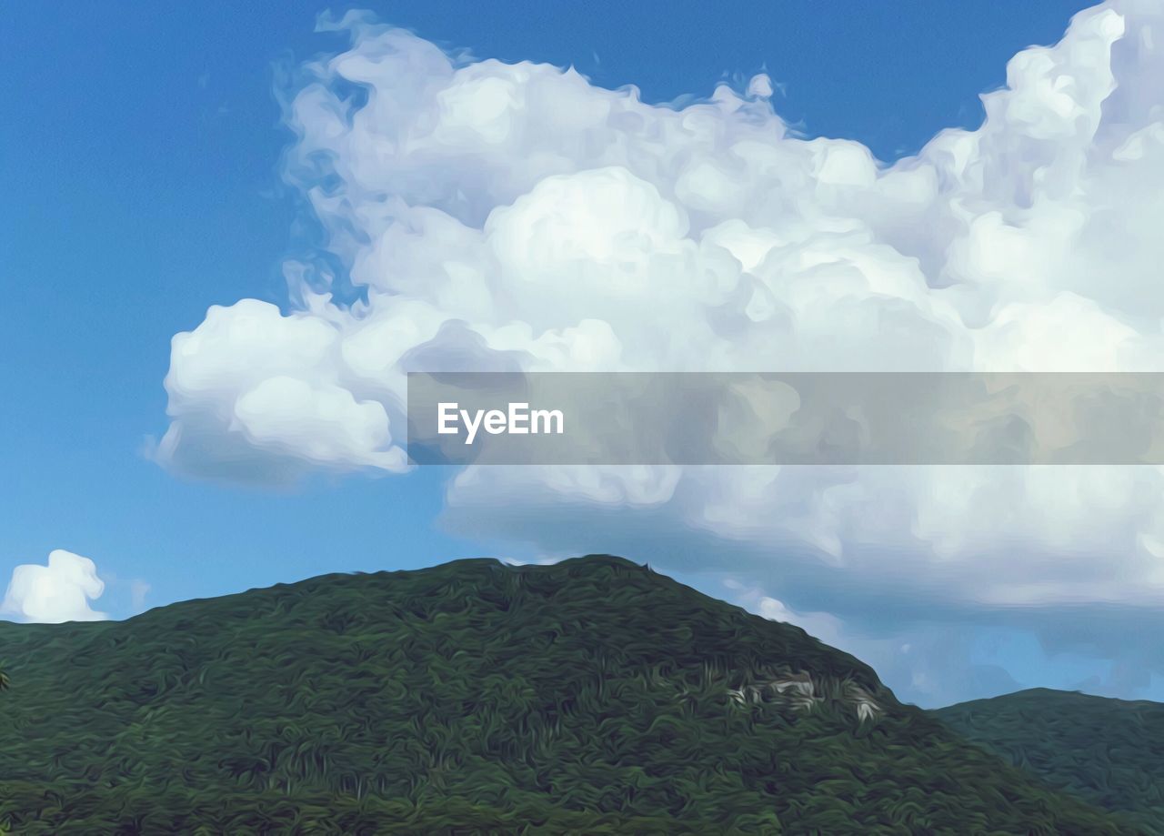 LOW ANGLE VIEW OF CLOUDS OVER MOUNTAIN