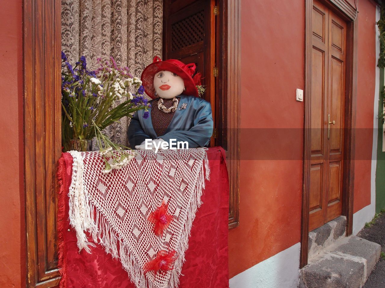 REAR VIEW OF BOY SITTING IN HOUSE AT ENTRANCE