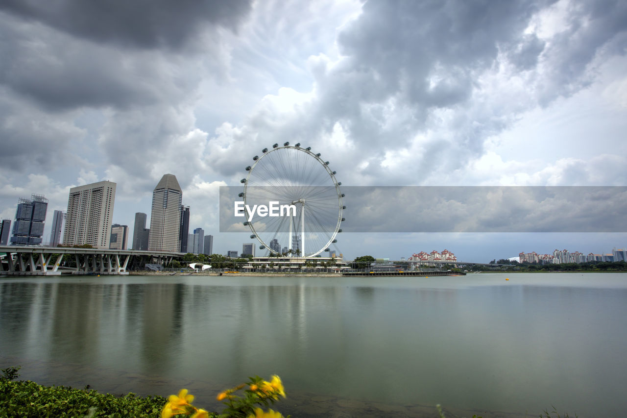 RIVER BY CITY AGAINST SKY