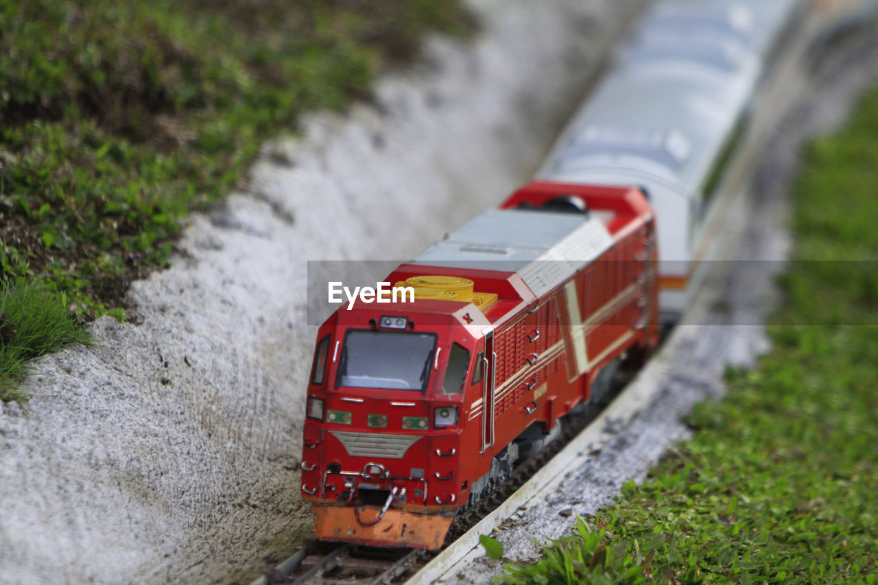 HIGH ANGLE VIEW OF TRAIN BY RAILROAD TRACKS