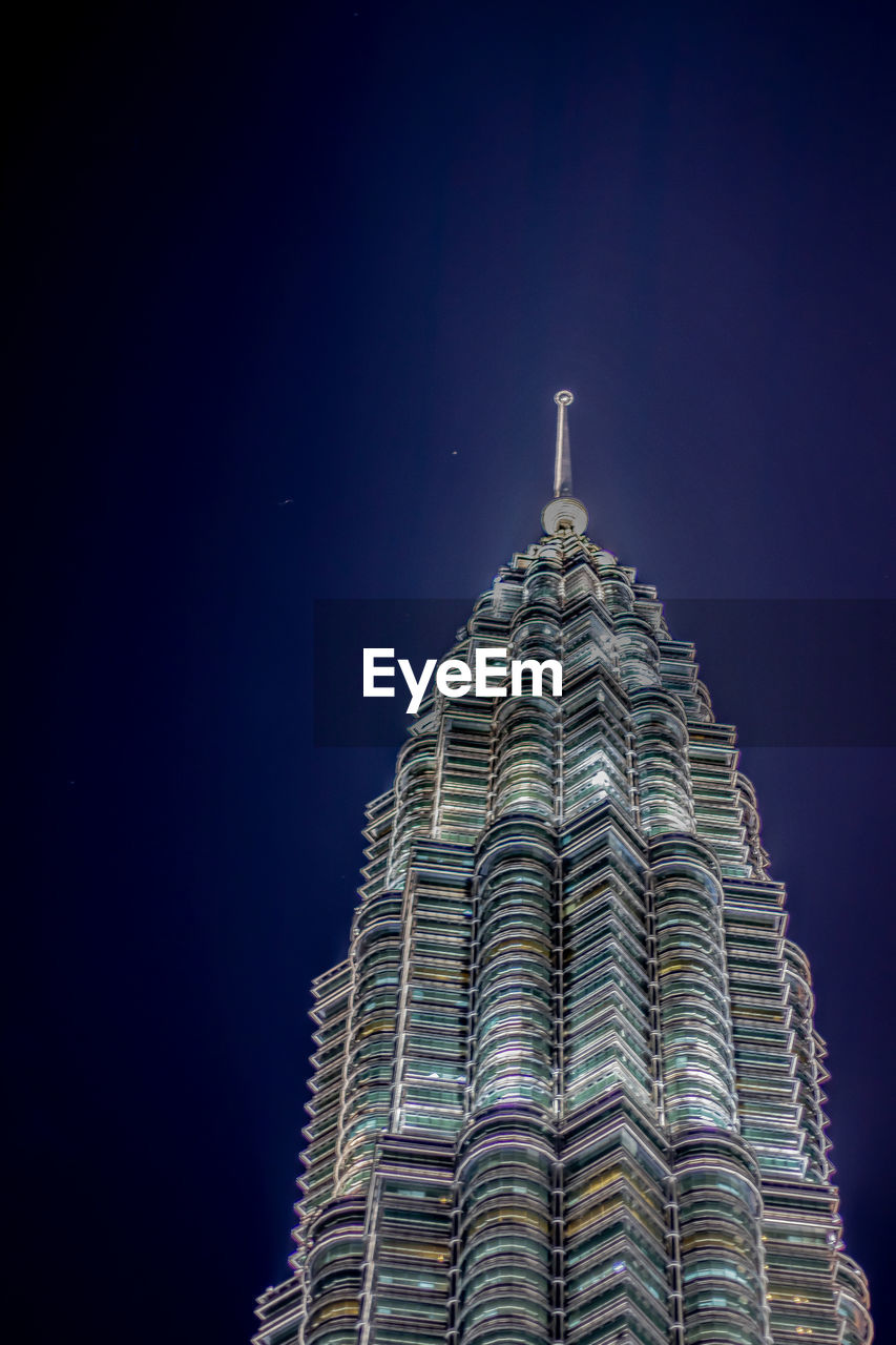 Low angle view of illuminated building against sky at night