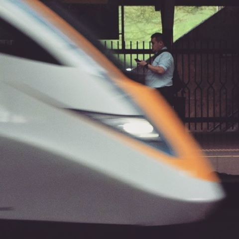 CLOSE-UP OF TRAIN ON ROAD