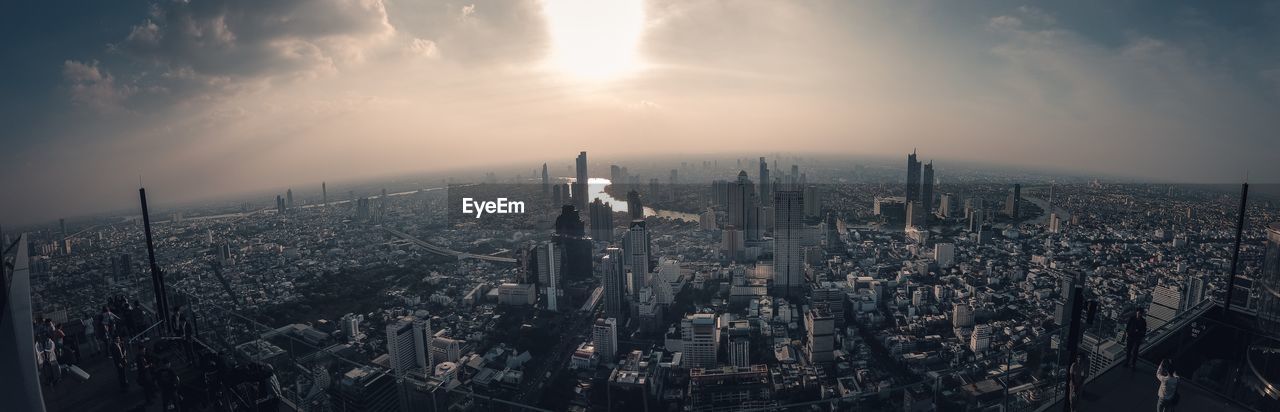 High angle view of buildings against cloudy sky