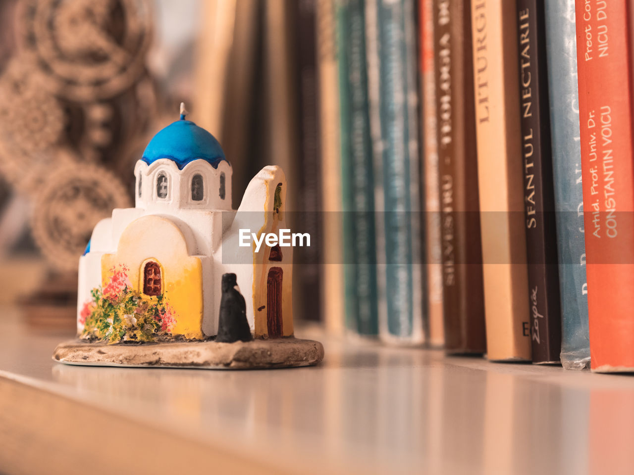 no people, religion, indoors, belief, figurine, celebration, tradition, spirituality, selective focus, table, decoration, book, publication, representation, still life, human representation, architecture, holiday