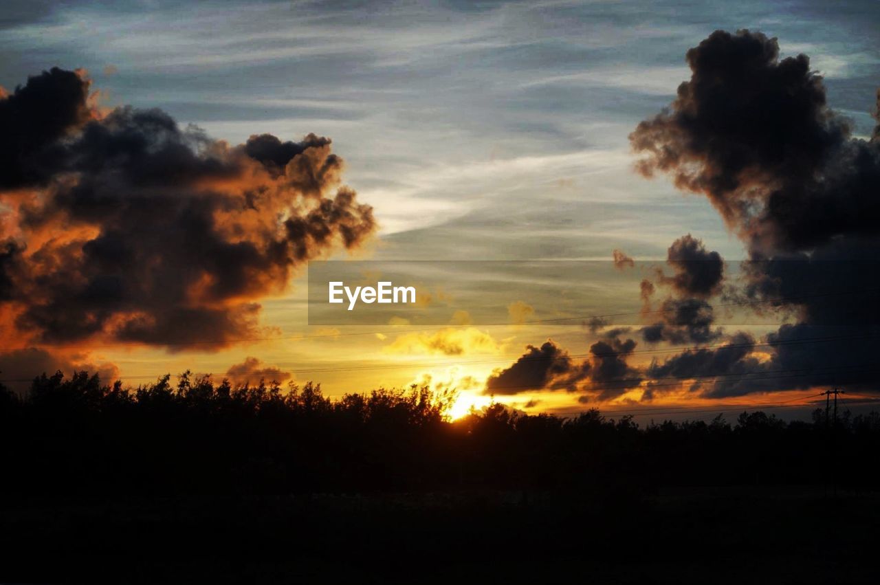 Low angle view of dark clouds during sunset