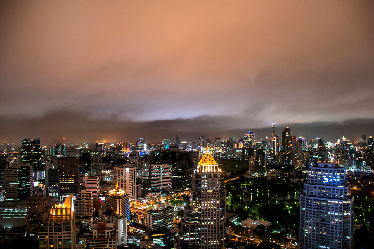 High angle view of illuminated cityscape against sky at night