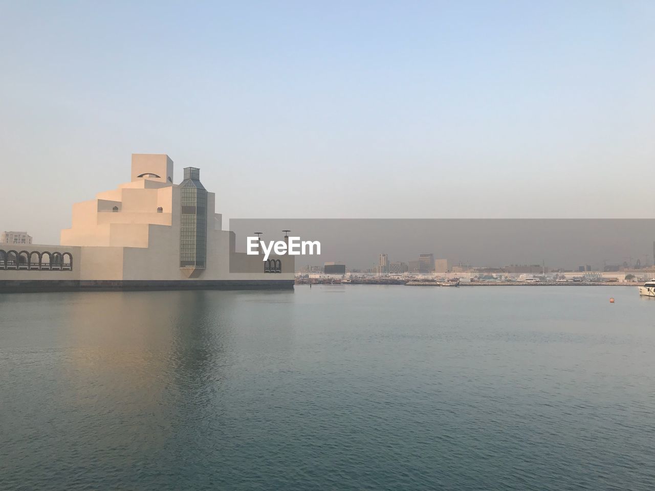 BUILDINGS BY SEA AGAINST SKY