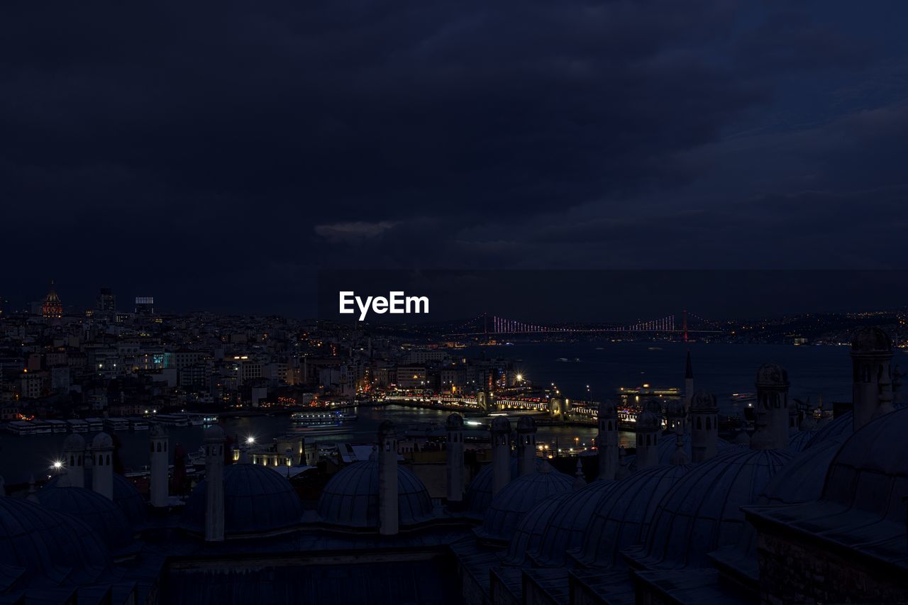 High angle view of city lit up at night