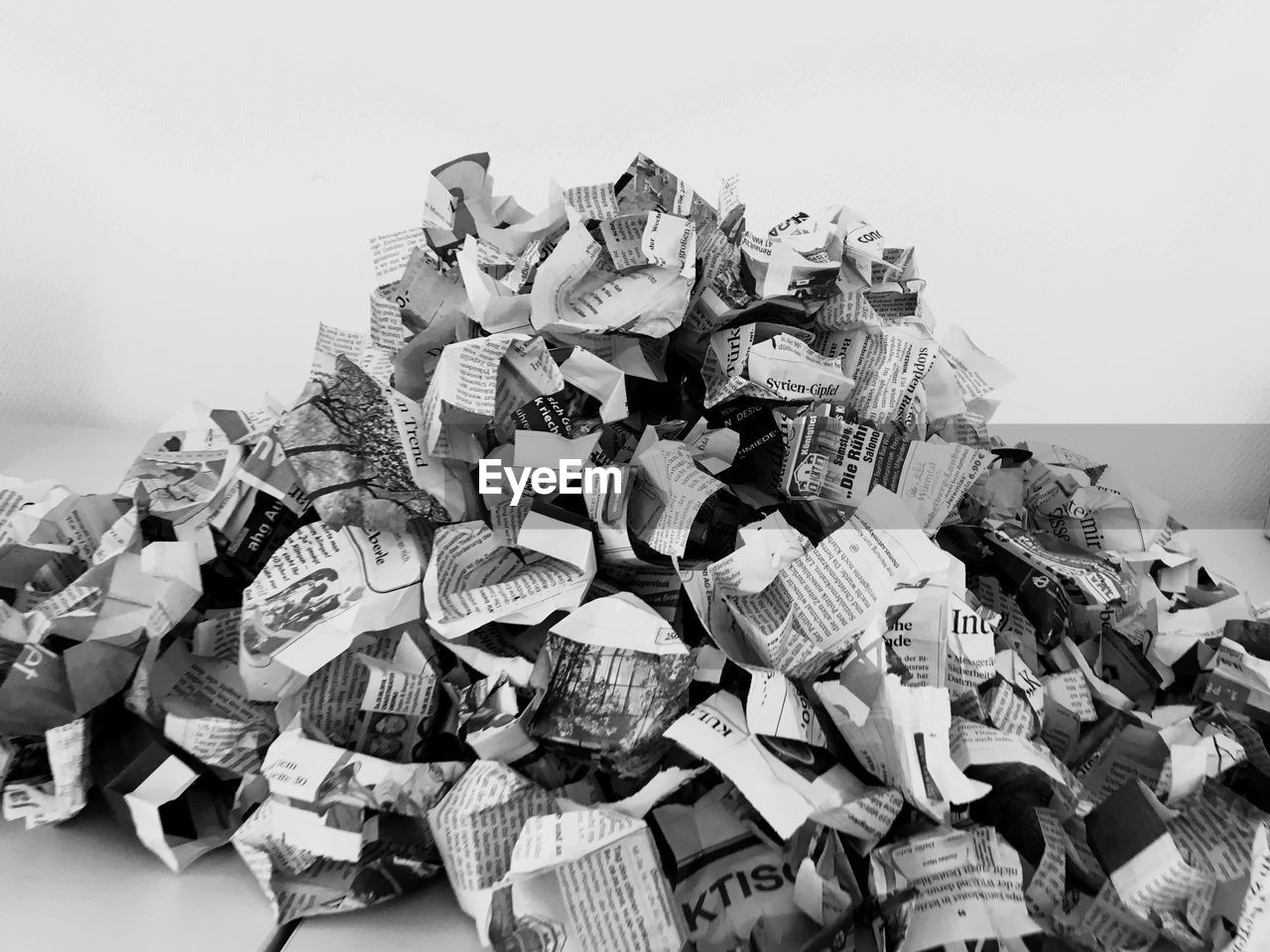 Close-up of crumpled newspapers on table