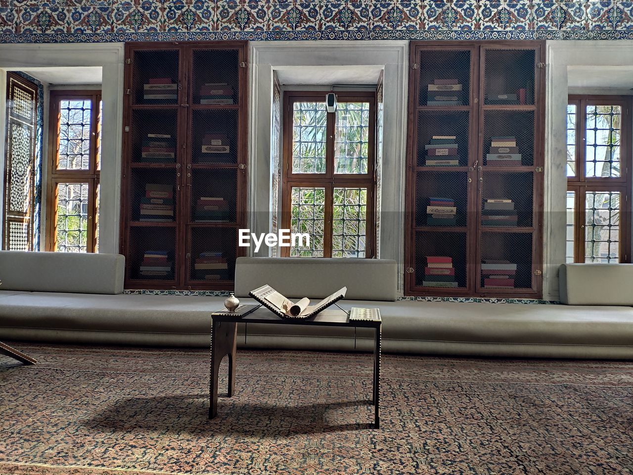 EMPTY CHAIRS AND TABLE IN WINDOW OF BUILDING