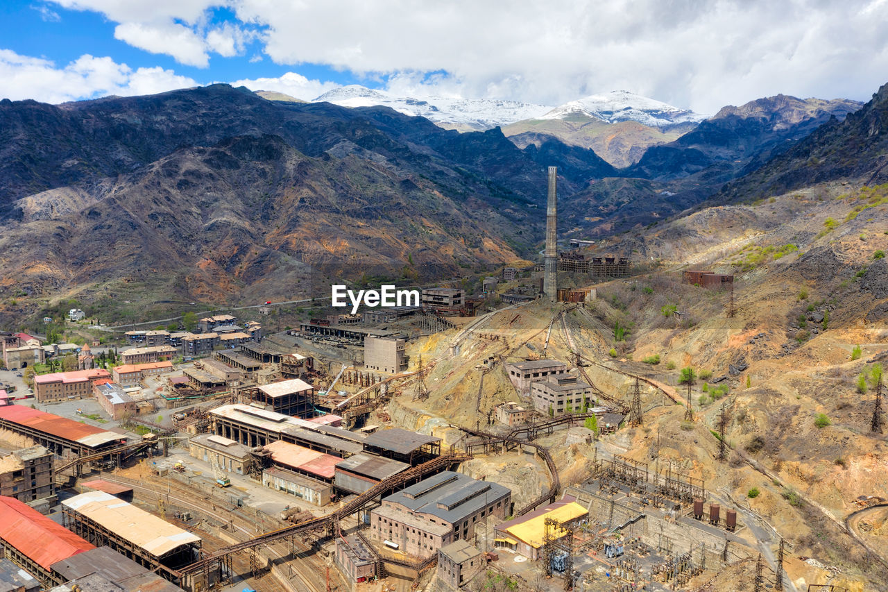 High angle view of townscape and mountains against sky