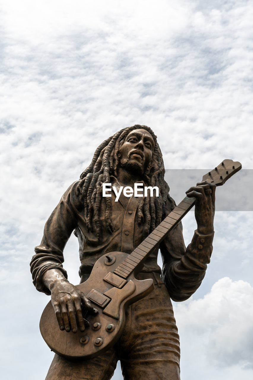 LOW ANGLE VIEW OF STATUE AGAINST SKY AND CLOUDS