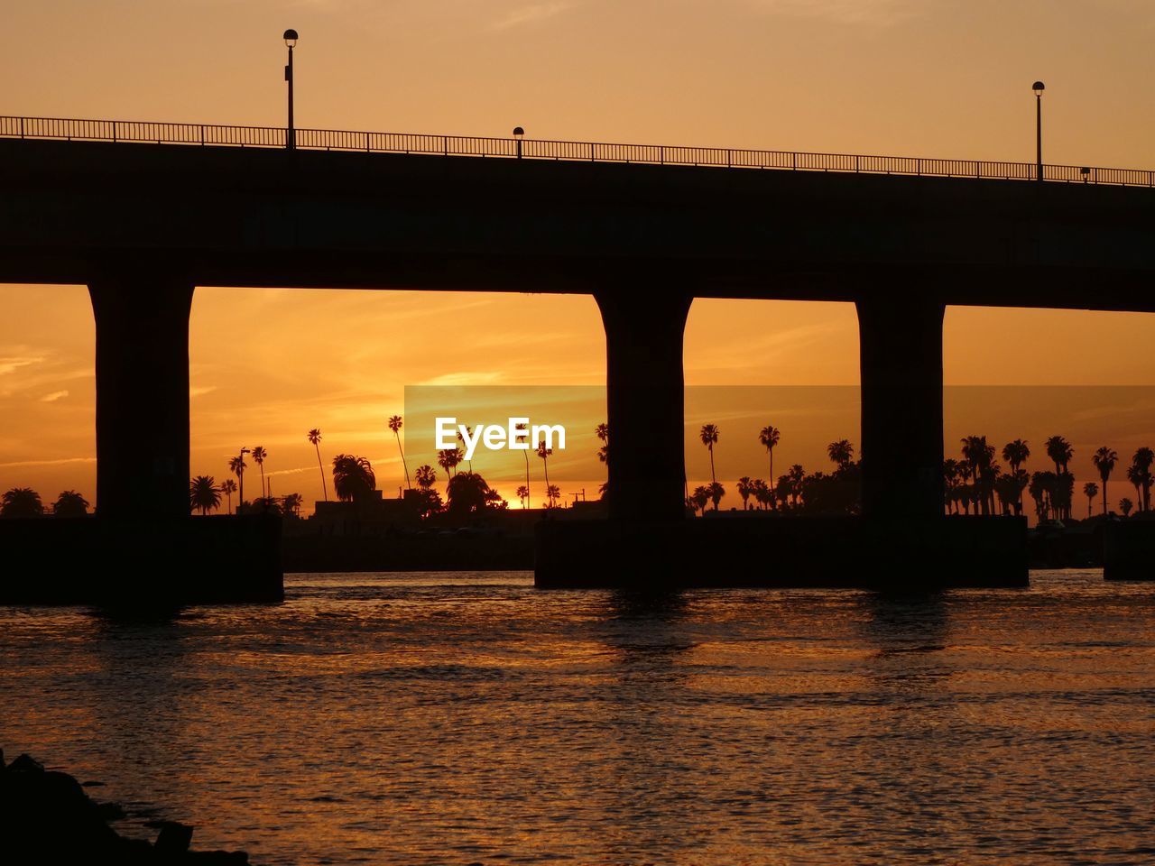 silhouette bridge over river