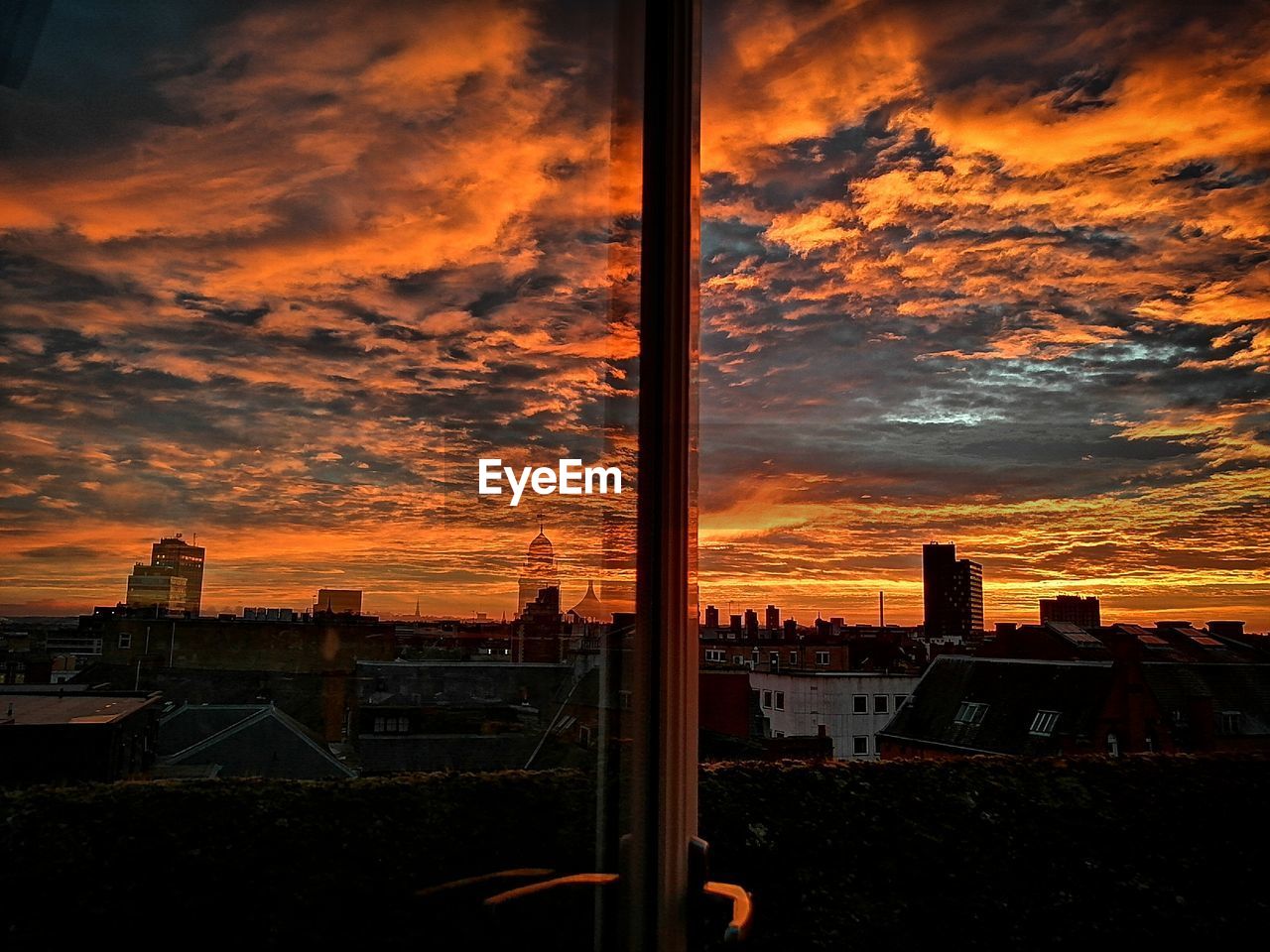 Silhouette buildings against sky during sunset