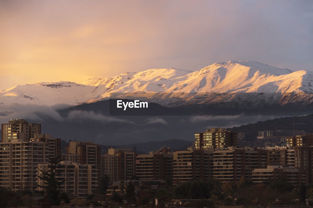 Snowcapped mountains against sky during sunset