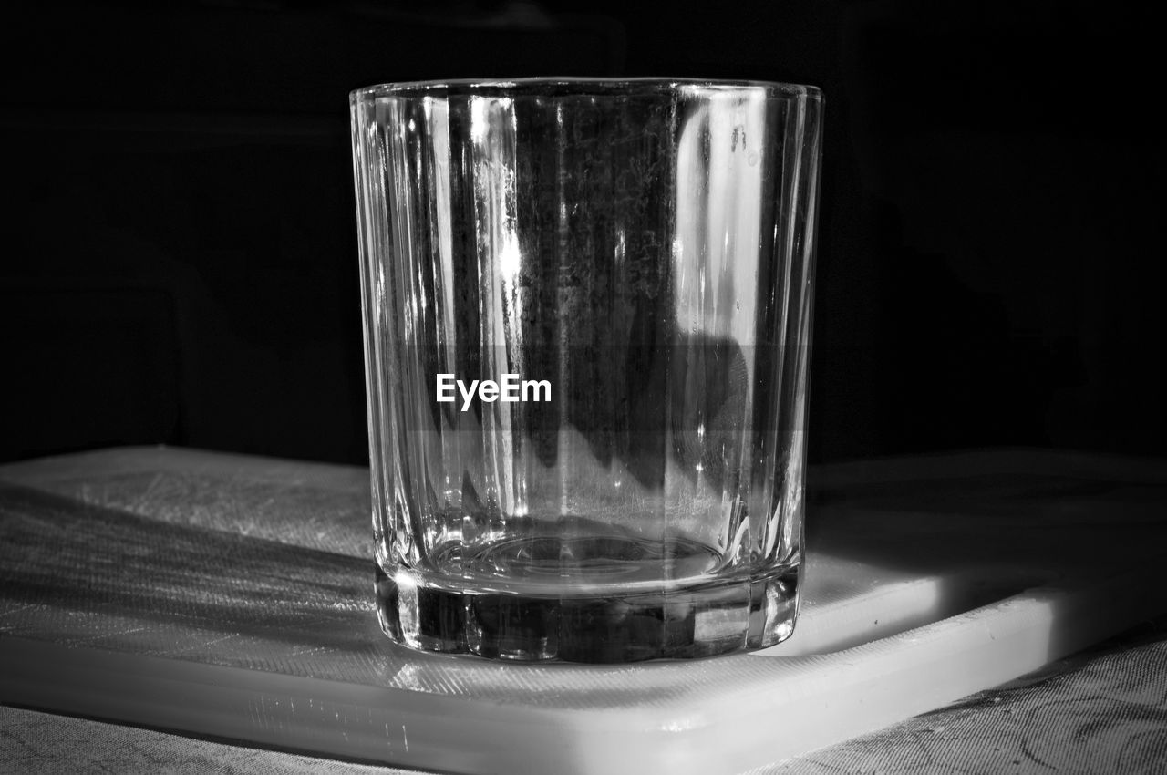 CLOSE-UP OF WATER IN DRINKING GLASS ON TABLE