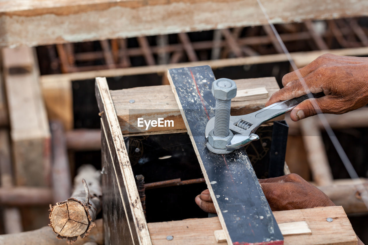 Cropped hand of carpenter working on wood