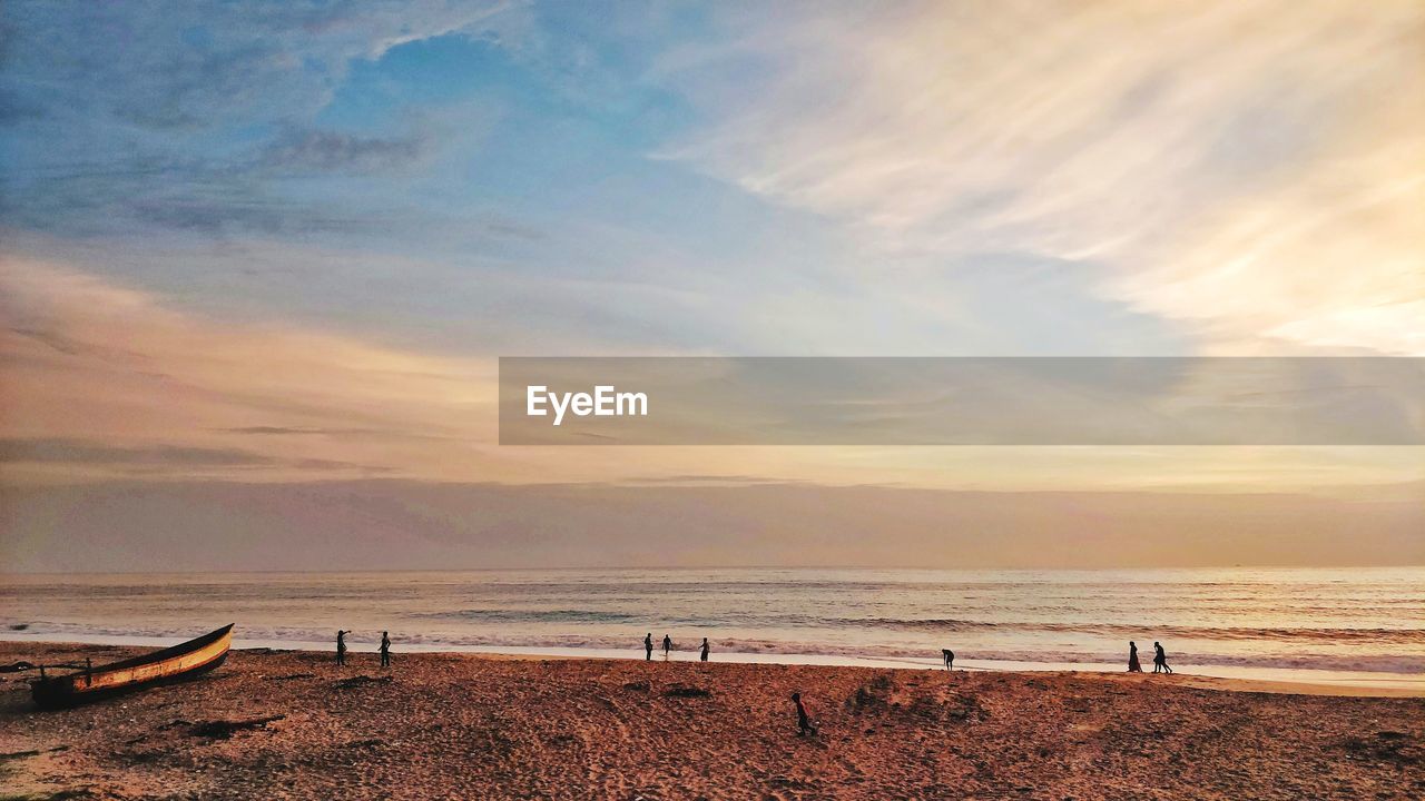 Scenic view of beach against sky during sunset