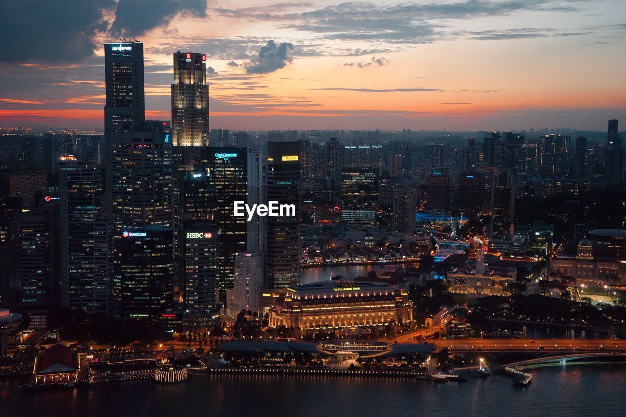 Aerial view of city lit up at sunset