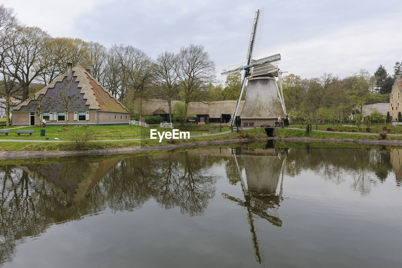 Built structure by lake against sky